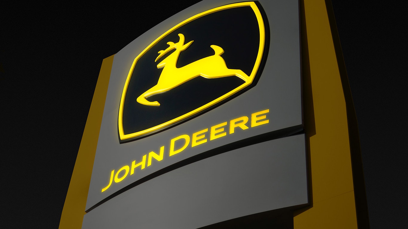 image of John Deere C&F sign lit up at night