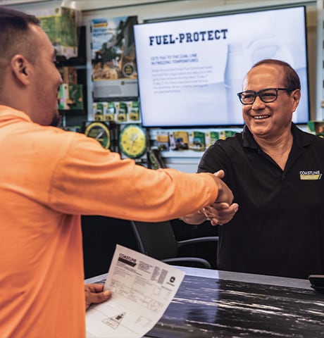John Deere dealer shaking hands with a customer