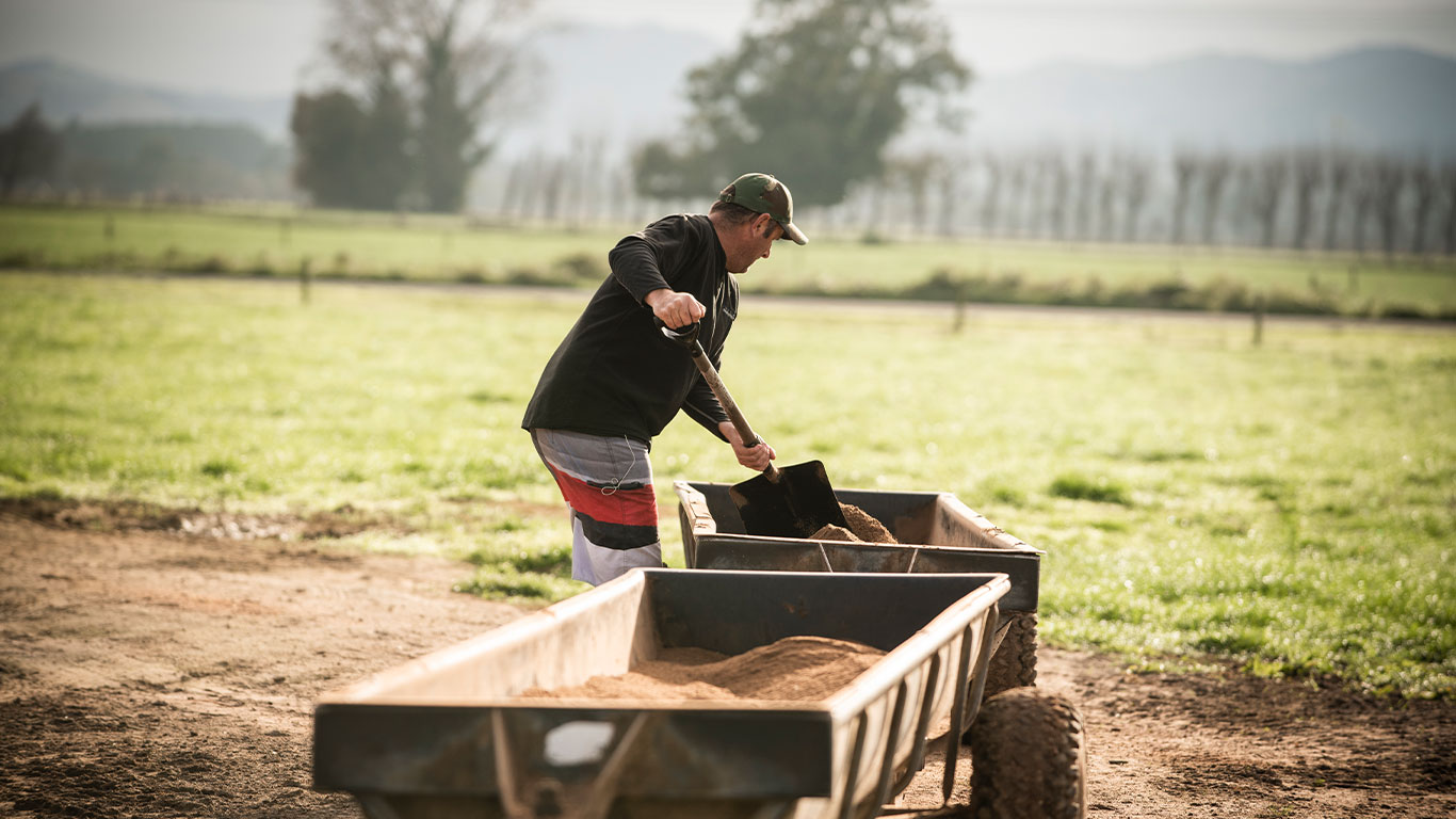 Man shoveling a trough