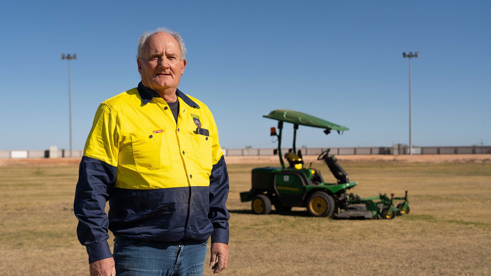 John Whittaker standing in front of tractor on the Coober Pedy Oval