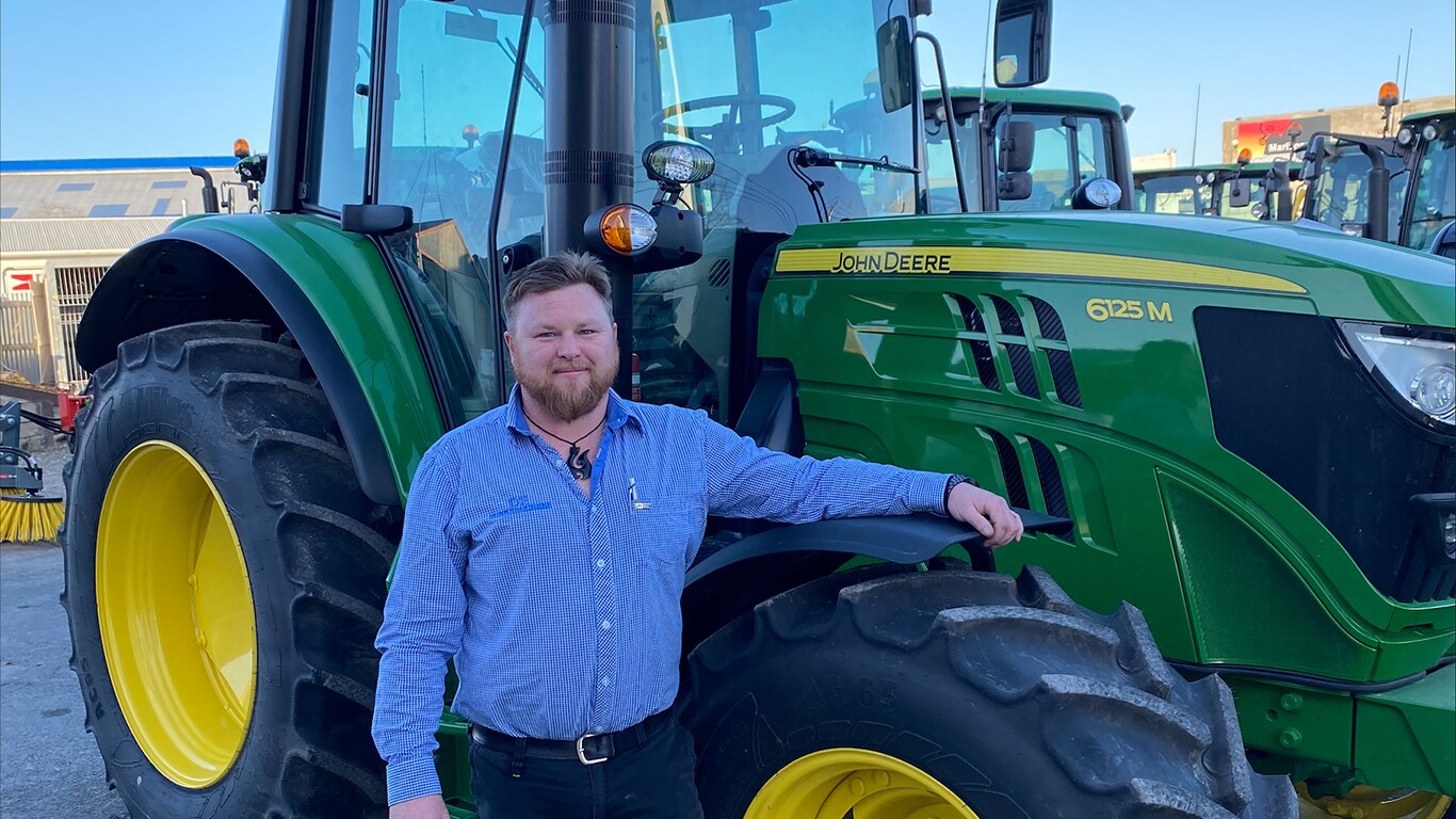 Jimmy O'Donnell next to his 6125M John Deere tractor