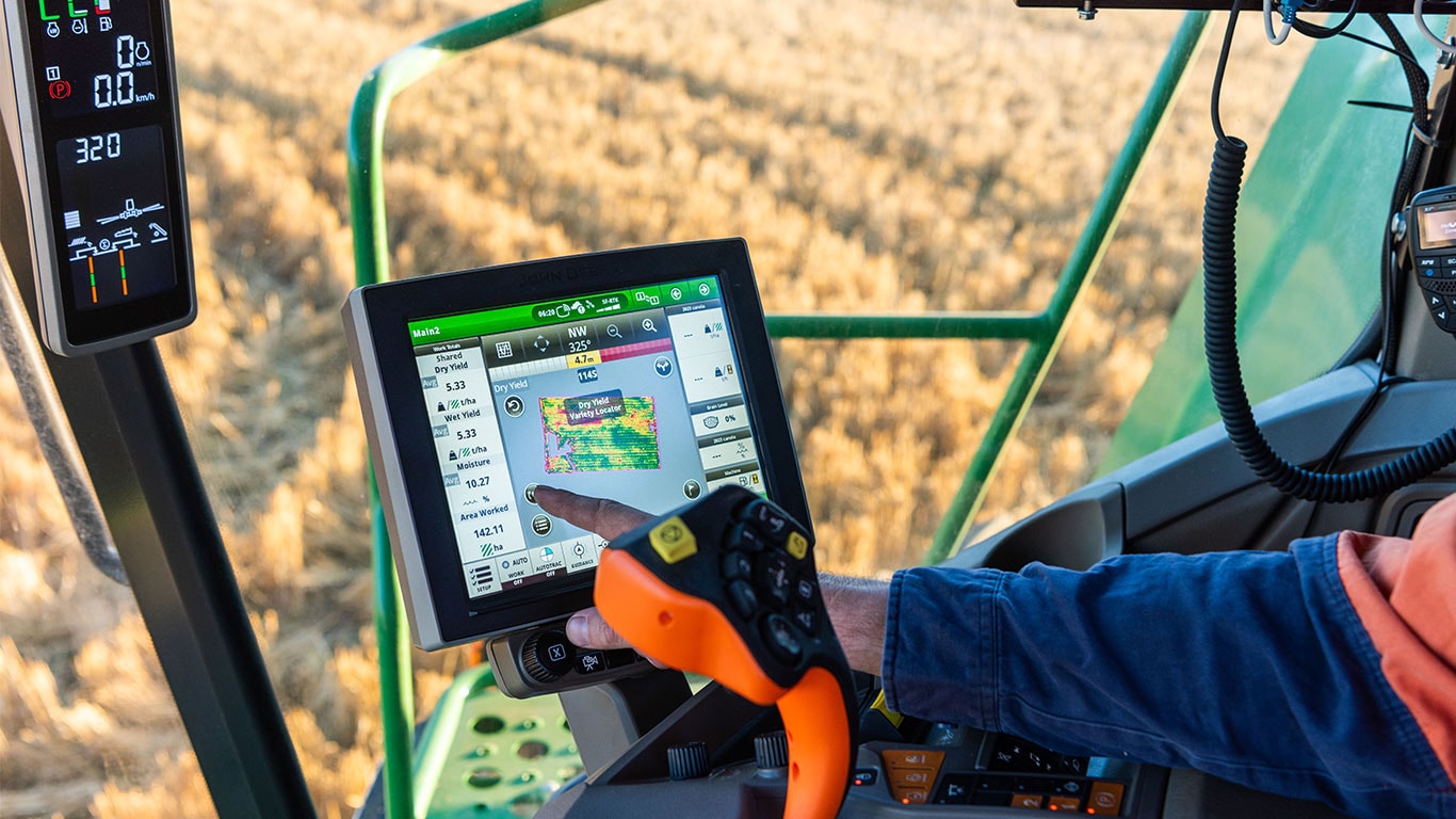 X9 Combine Harvester cab with display showing a yield map