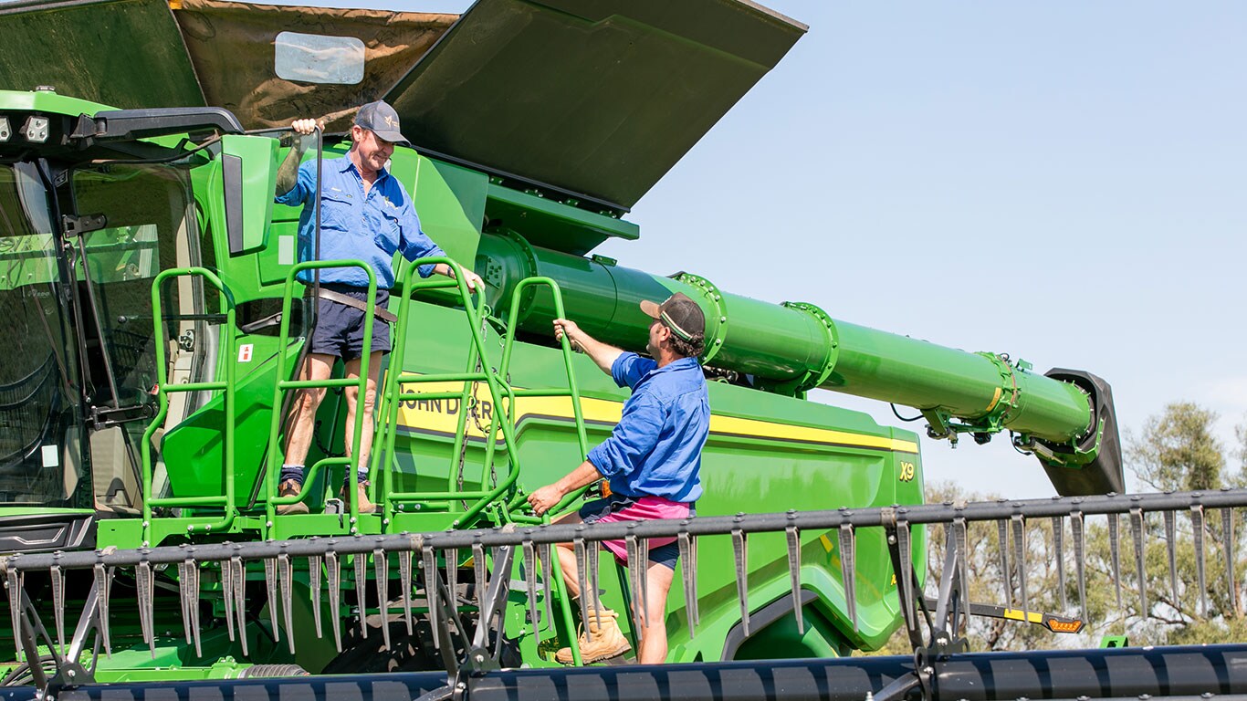 James Hardcastle and Jeff Fairbanks on an X9 Combine Harvester.