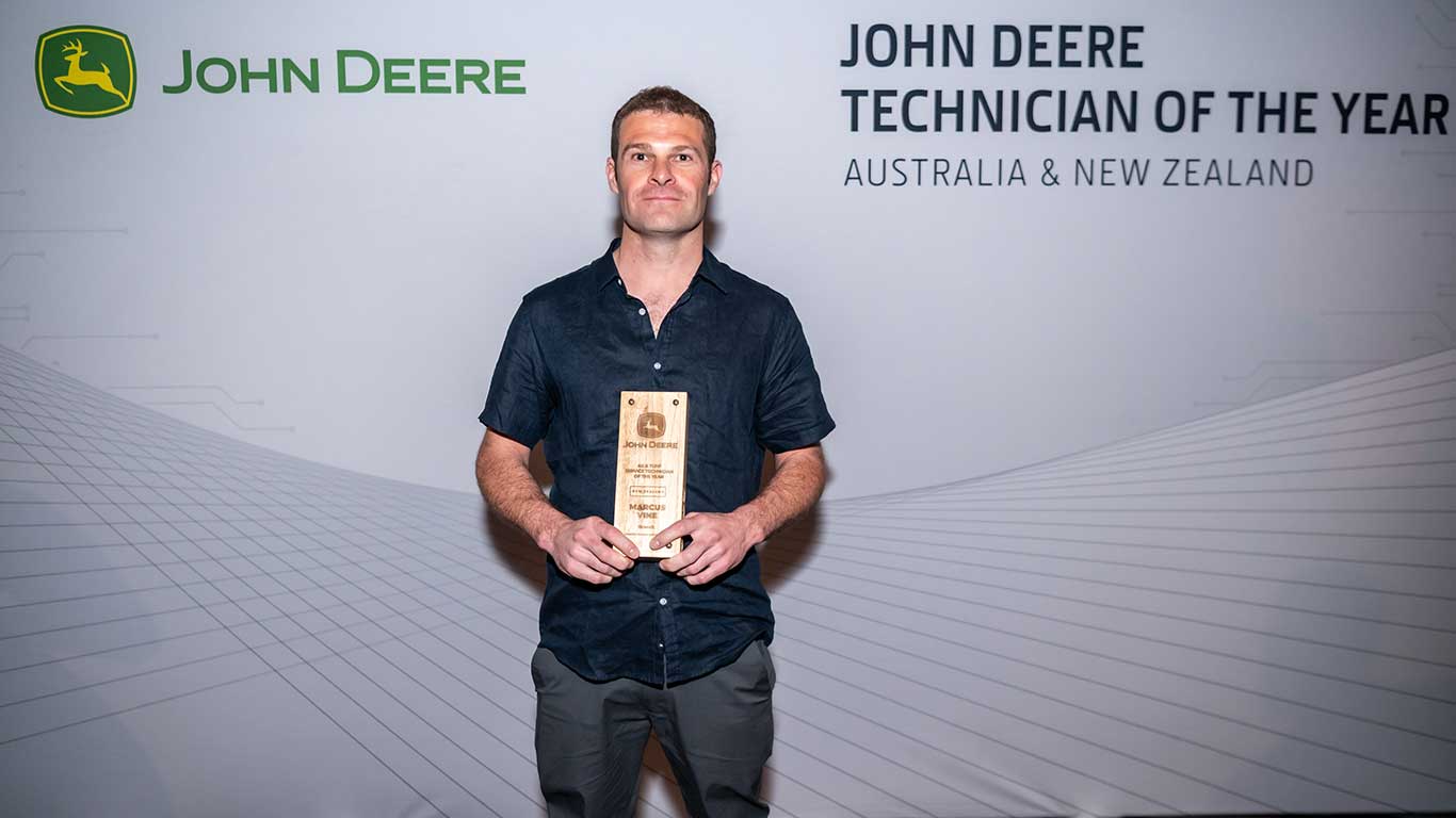 Marcus Vine displaying his award