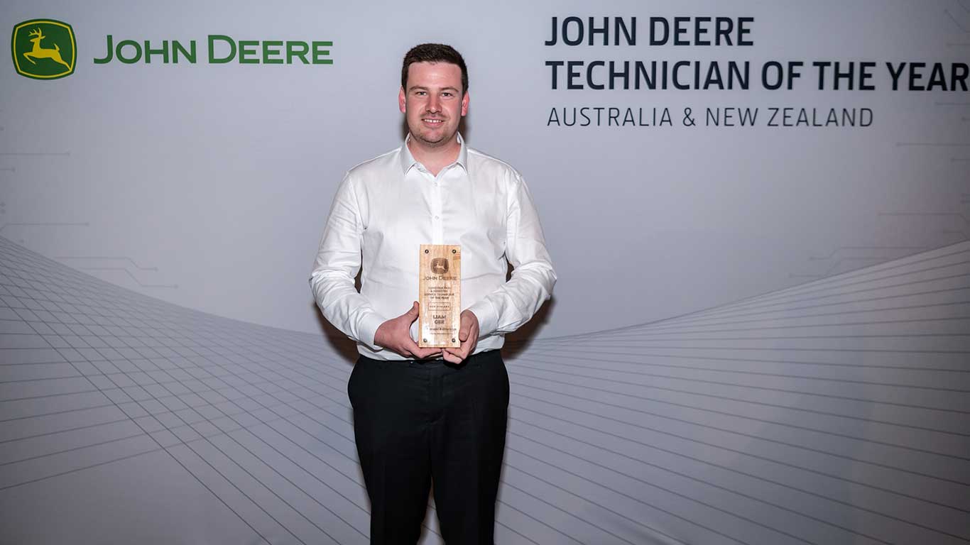 Andrew Moat displaying his award