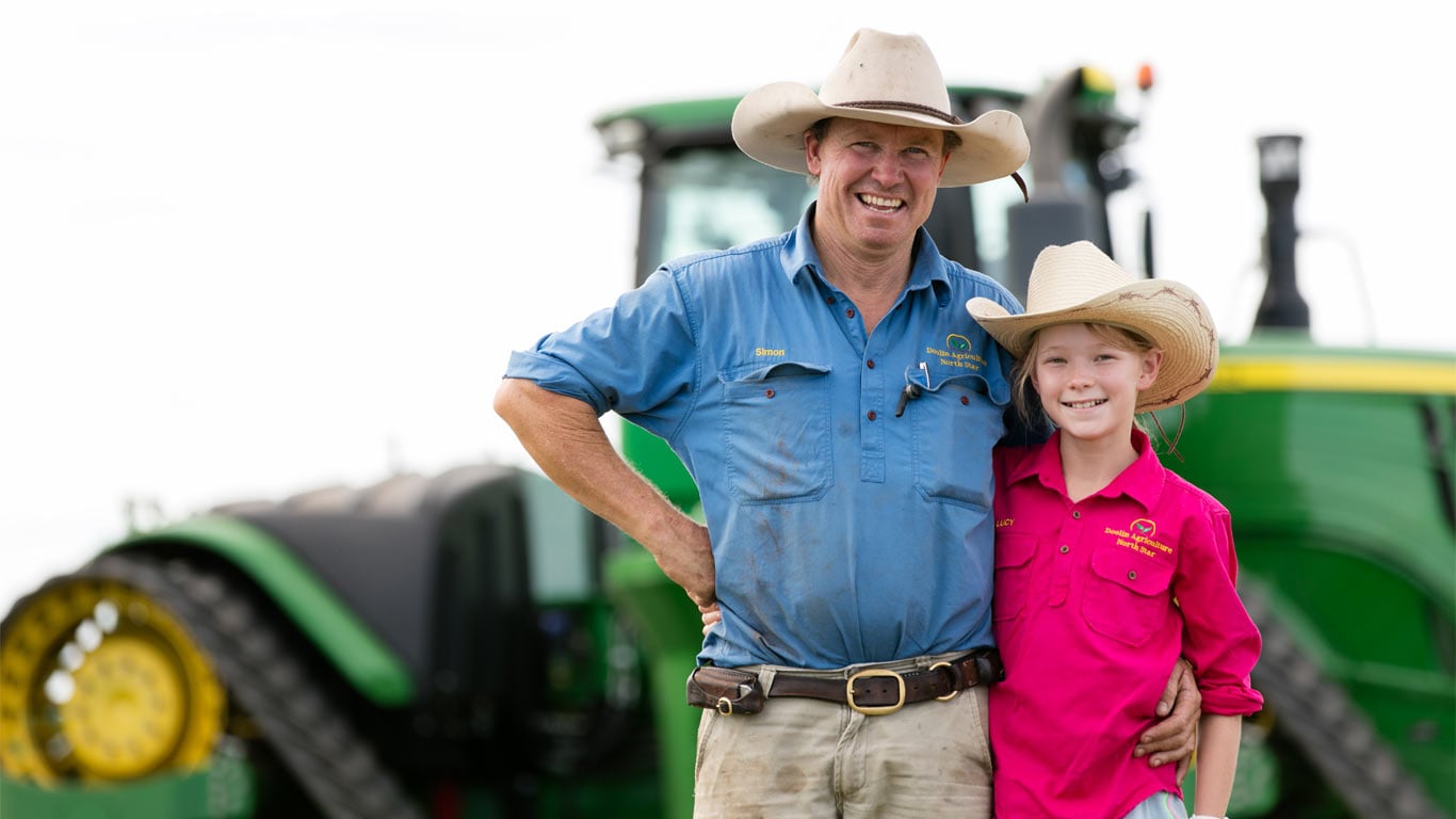 Simon and Lucy Doolin in front of a tractor.