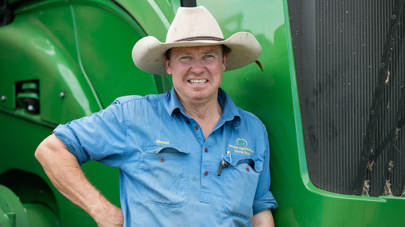 Simon Doolin in front of a tractor bonnet.