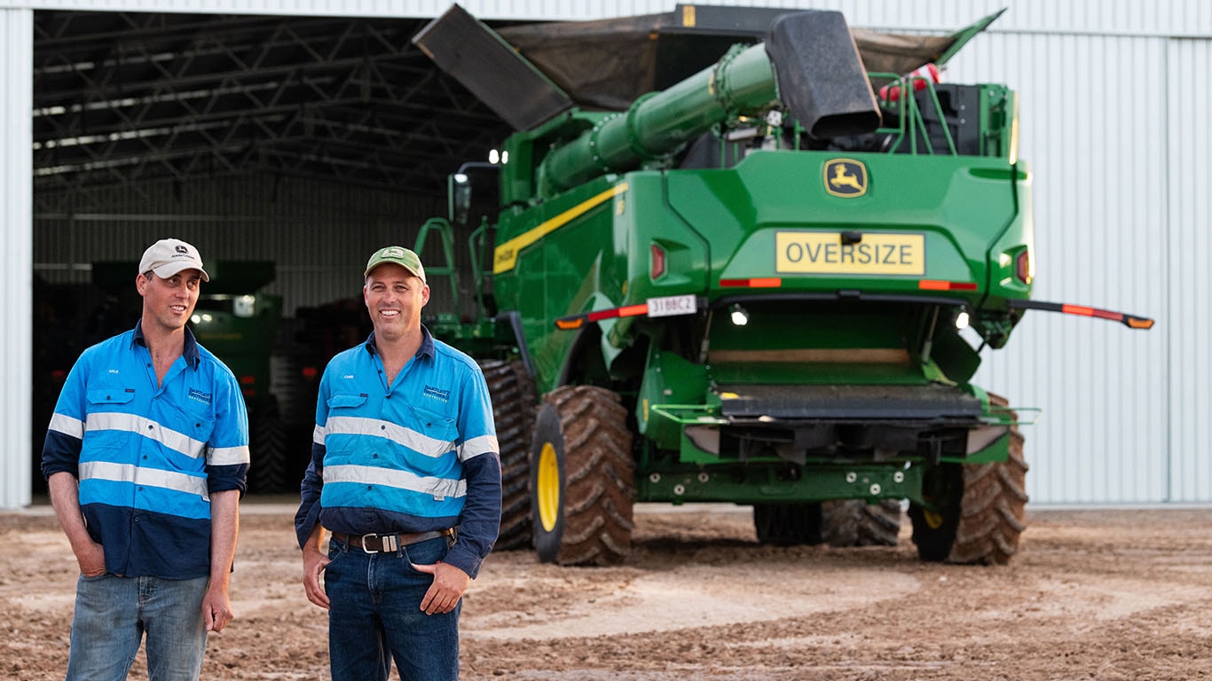 Two farmers, Chris and Dale Bartlett, with a John Deere Combine Harvester