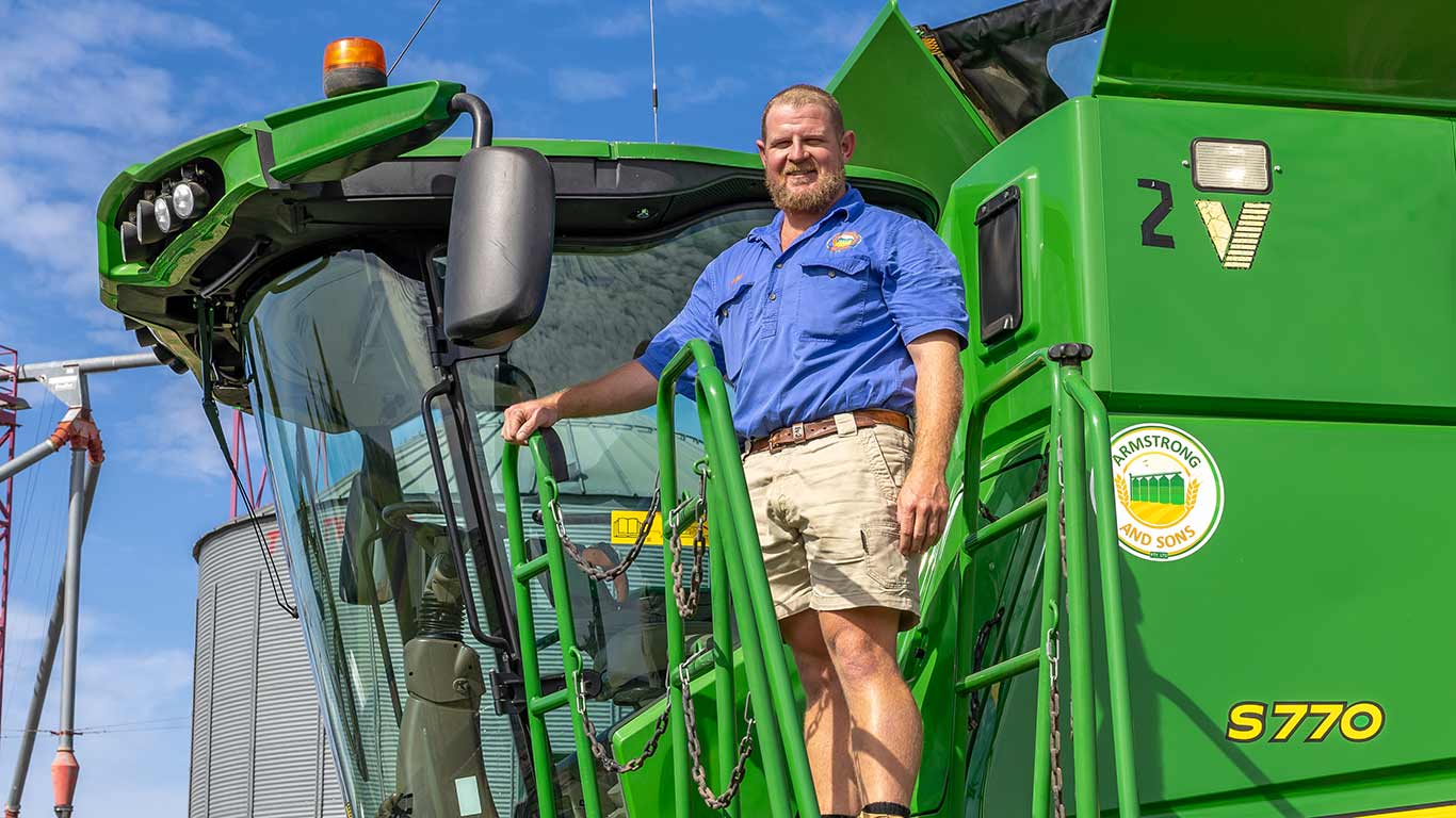 Xander Armstrong from Comet standing in front of an S770 combine