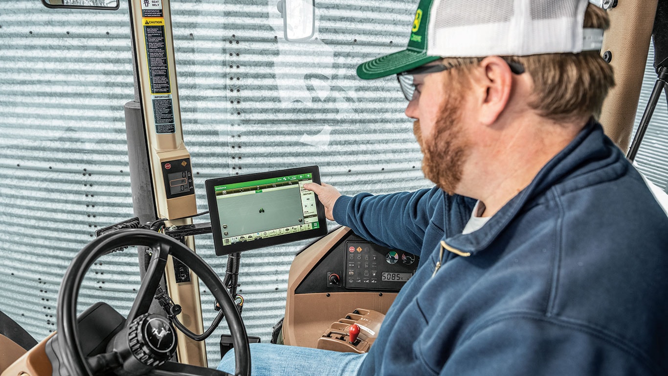 Farmer using a Precision Agriculture computer in a header.