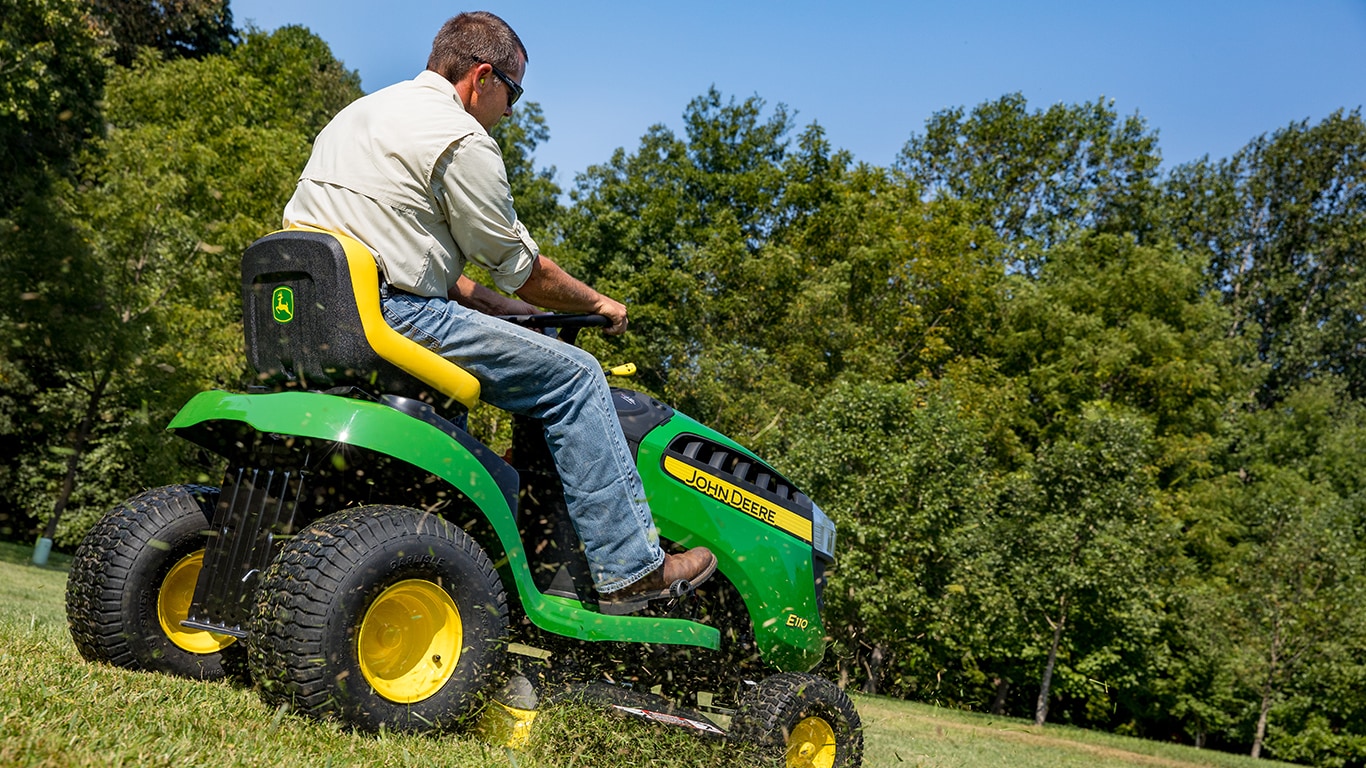 man riding a 100 series mower