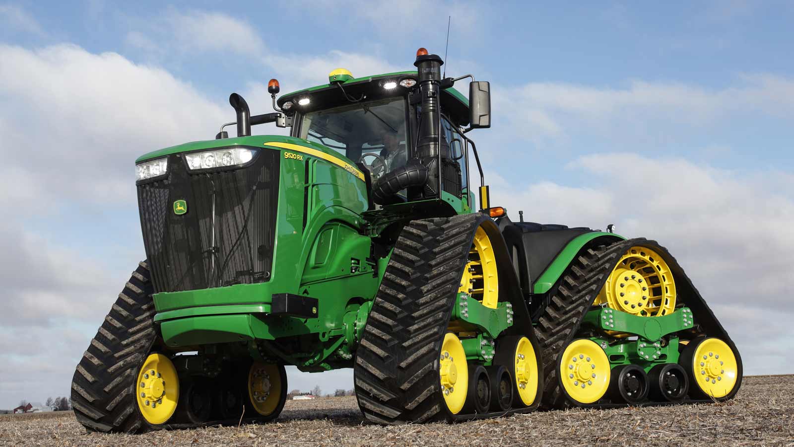 A 9R Family tractor facing to the left in a field