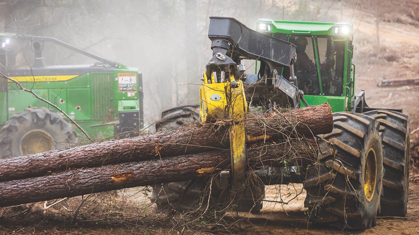 John Deere skidder working in a foggy wooded area