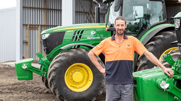 Andy Hey leans on his John Deere tractor