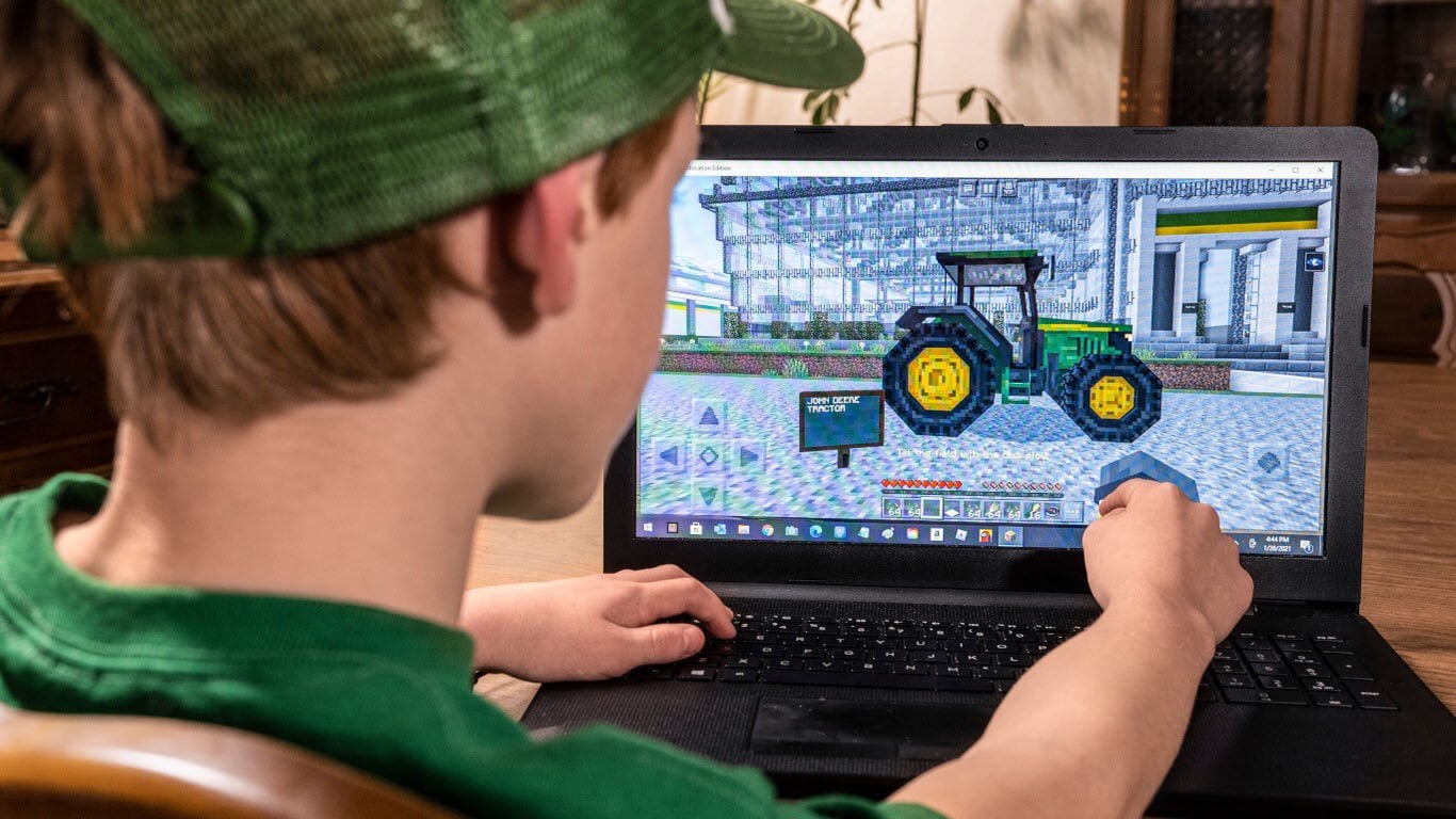 Child playing FarmCraft on a laptop