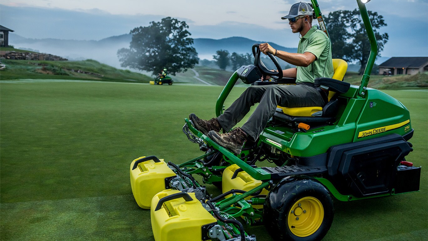 Man riding a triplex mower