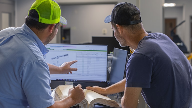 two men at a computer