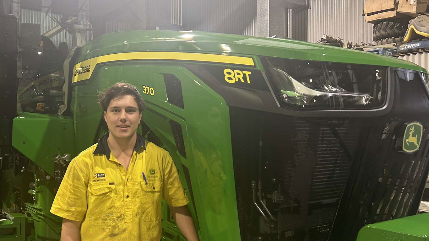Salvatore Bettio in front of John Deere equipment