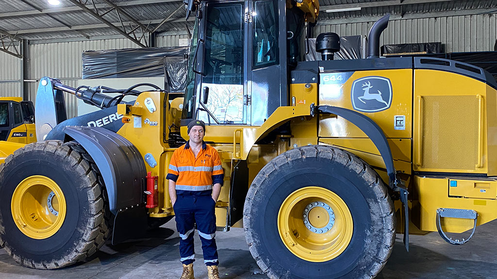 Max standing in front of 644 P-Tier Mid-Size Wheel Loader