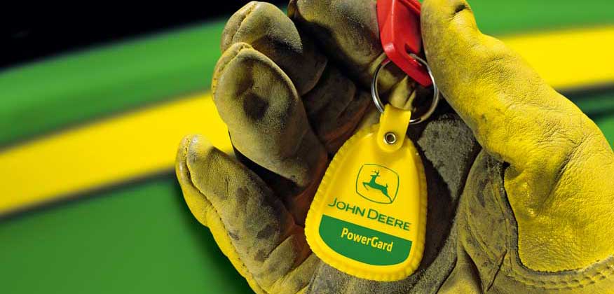 A gloved hand holding a PowerGard keychain