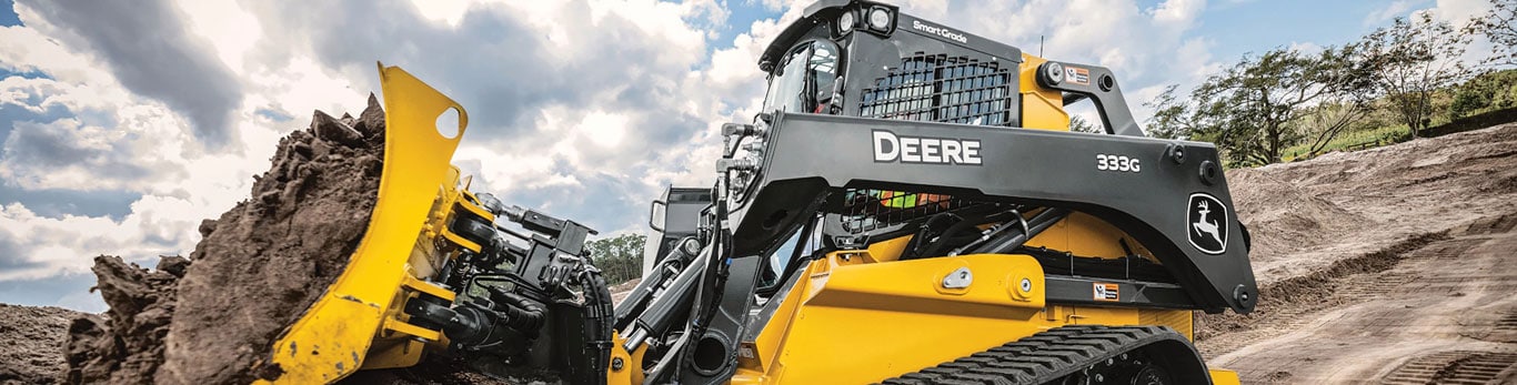 333G Compact Track Loader pushing dirt on worksite