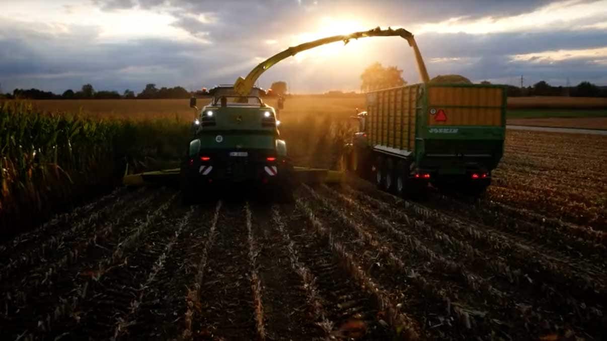 John Deere equipment harvesting grain into grain cart