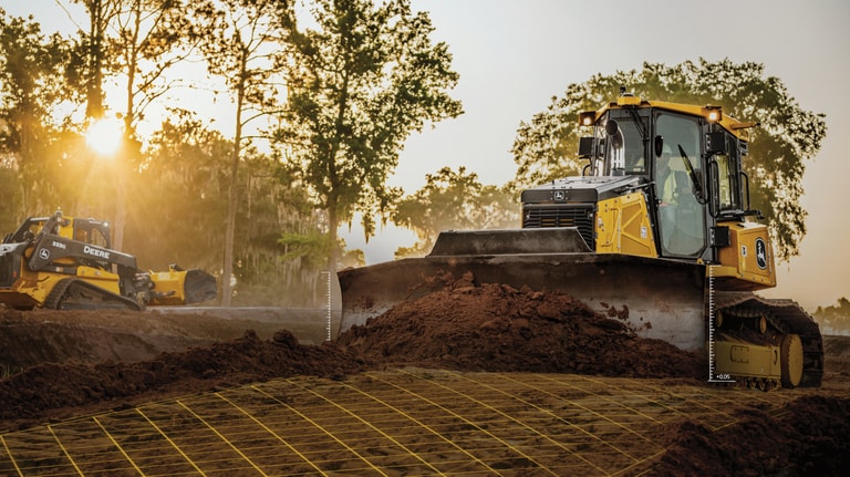 A 750L Dozer leveling dirt on a worksite with measurements and gridlines shown.