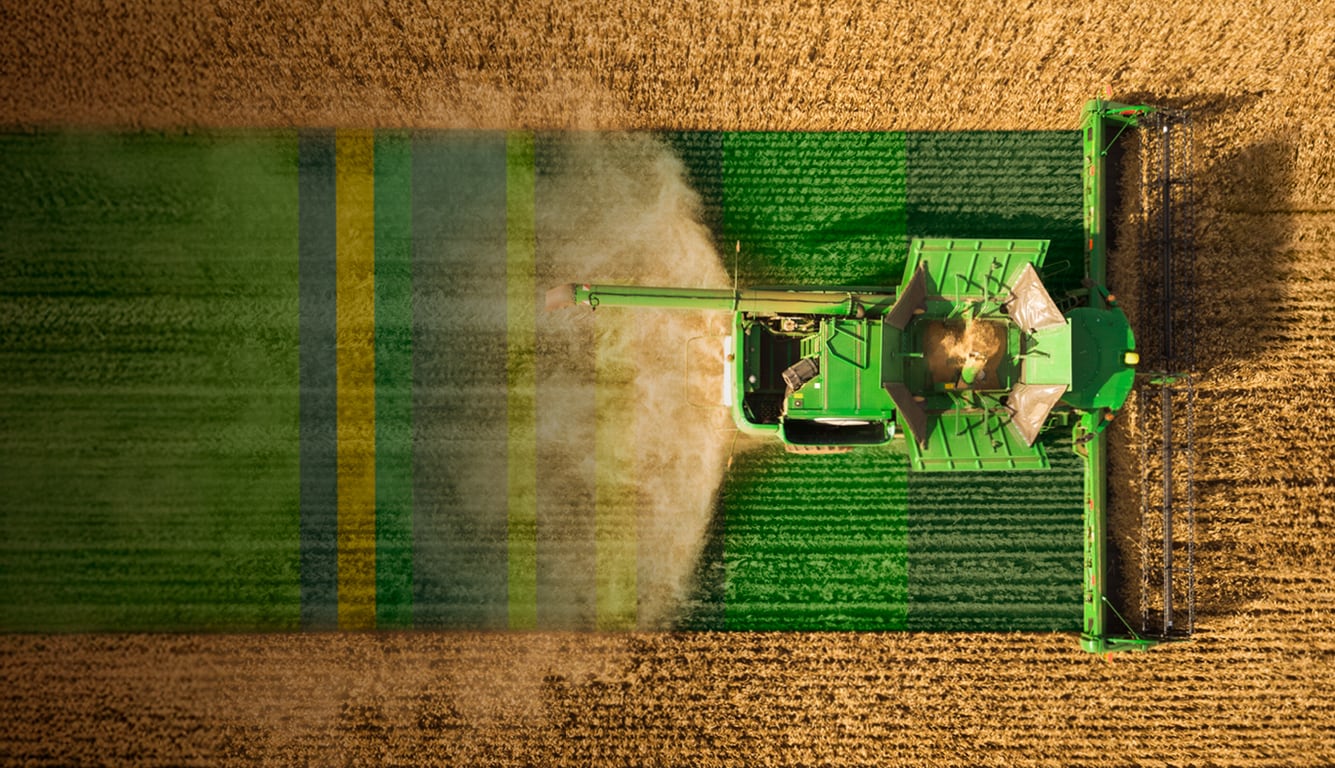 Combine harvester in a wheat field from above