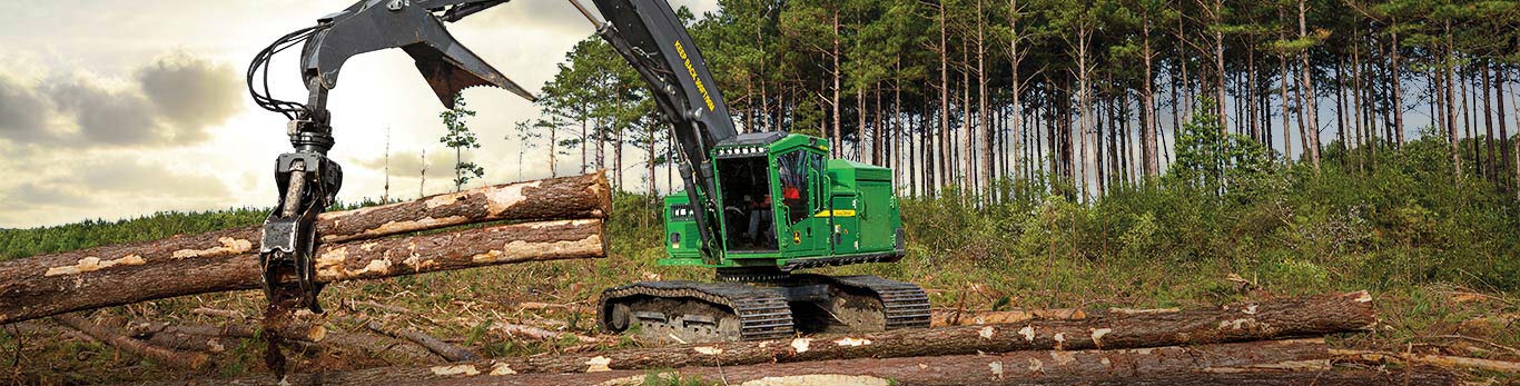 953MLSL shovel logger tackling wetland and soft ground moving felled trees