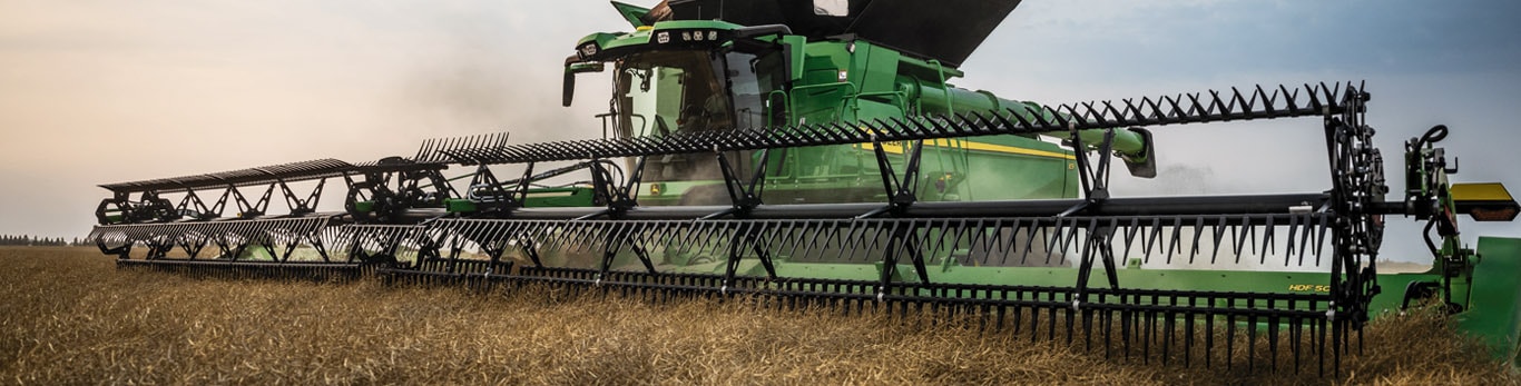 Combine harvesting in canola field