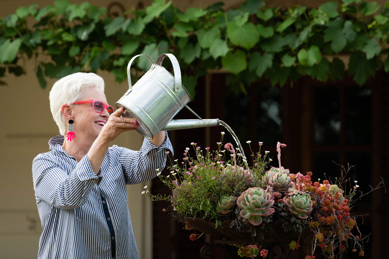 Julie Armstrong watering garden