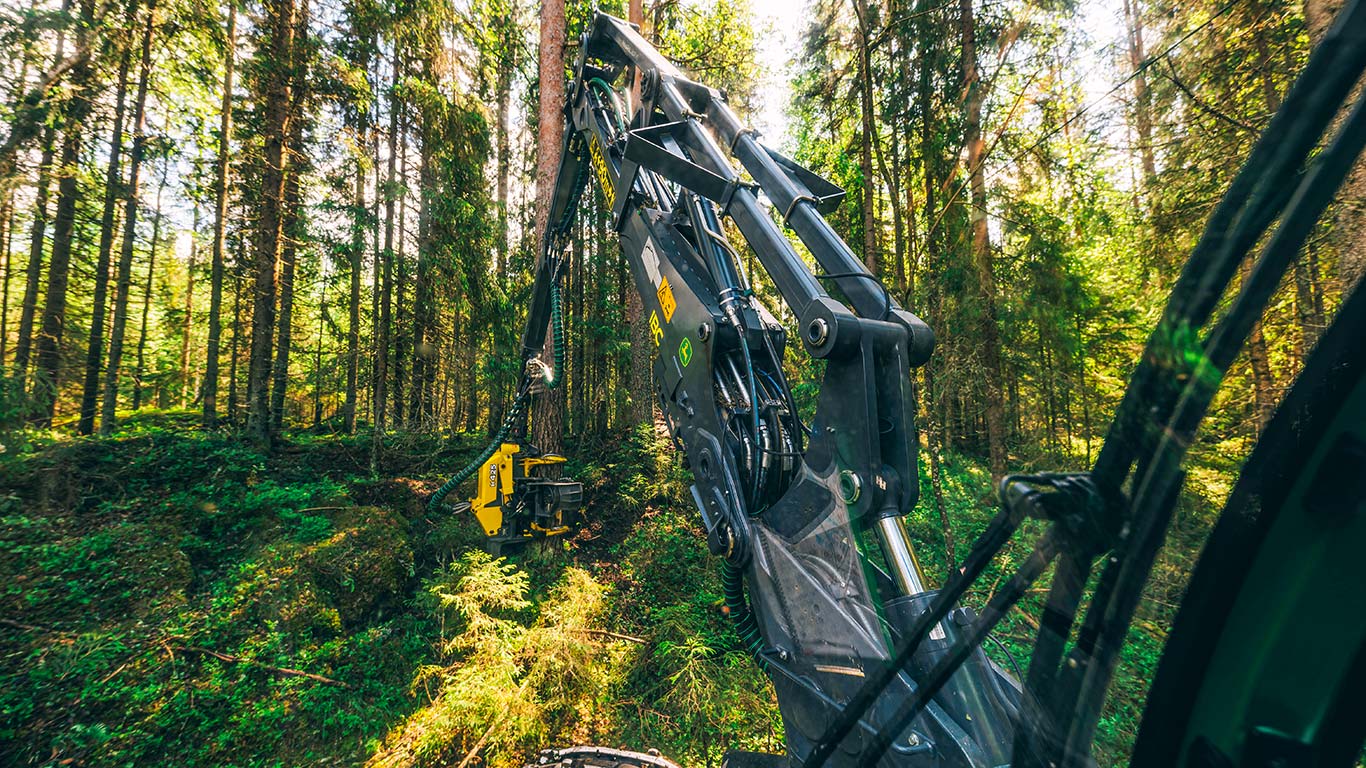 John Deere harvester boom and trees