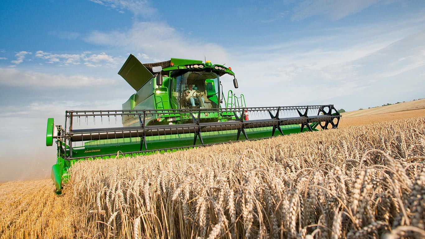 A combine going through a wheat field