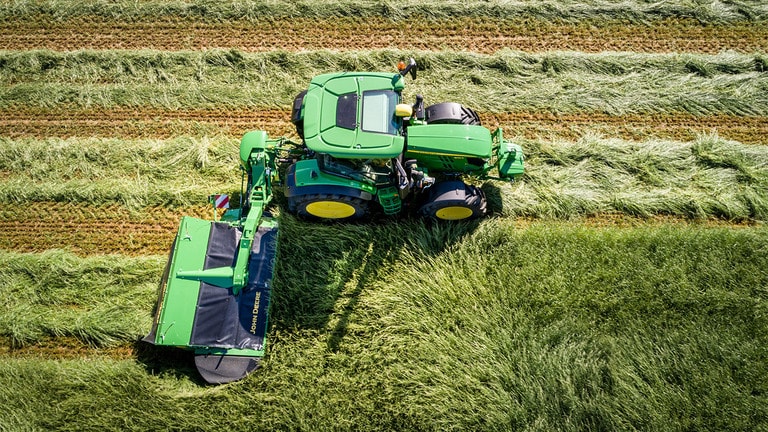 Aerial view of tractor in field using rear-mounted vertical-fold R310R