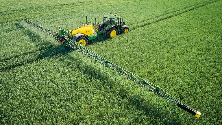 Trailed Sprayer R732I spraying crops