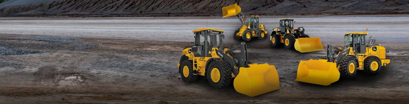 Various wheel loaders against a quarry background