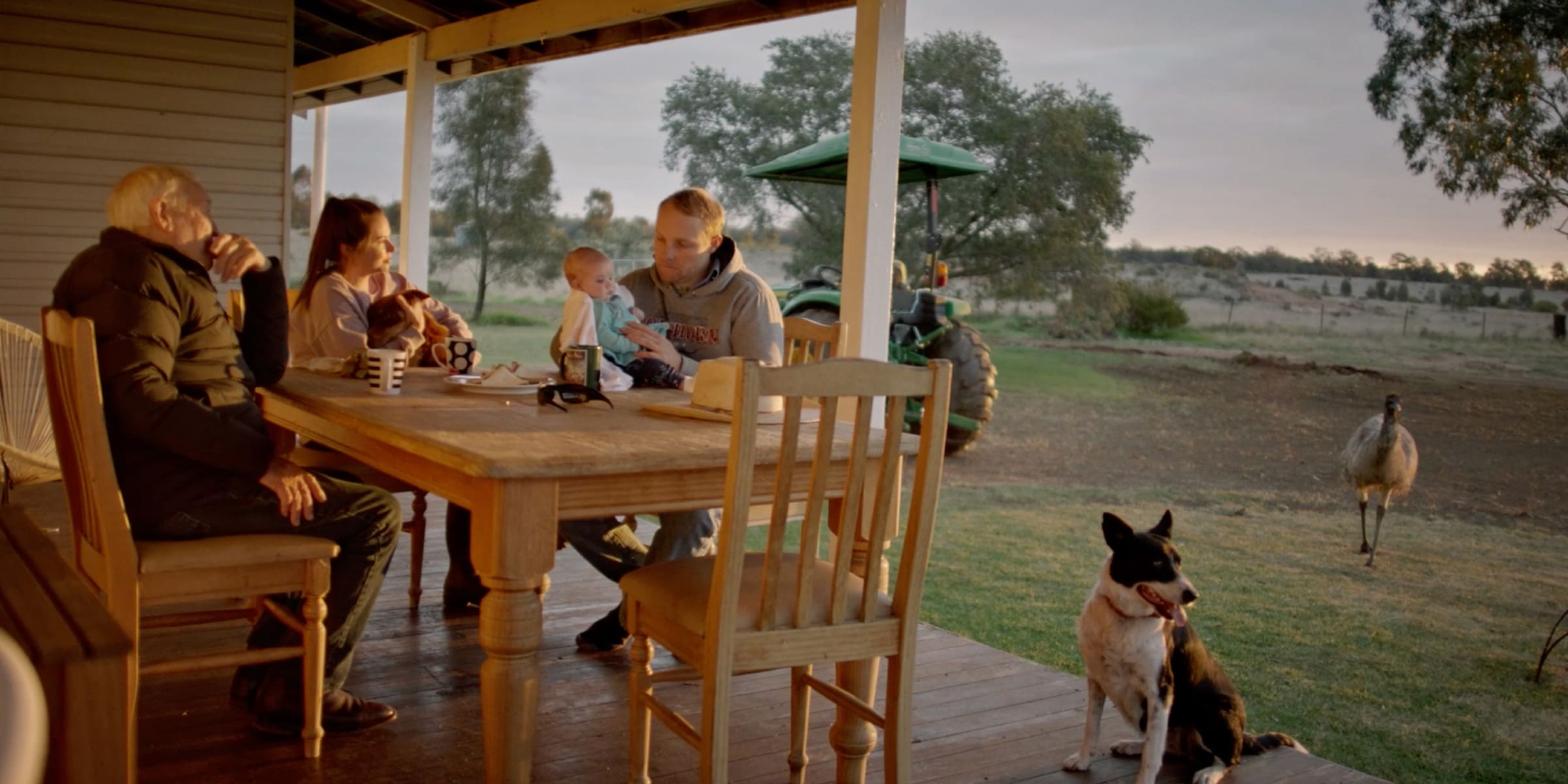 Will, Emma and their family sitting outside on their outdoor entertaining area.