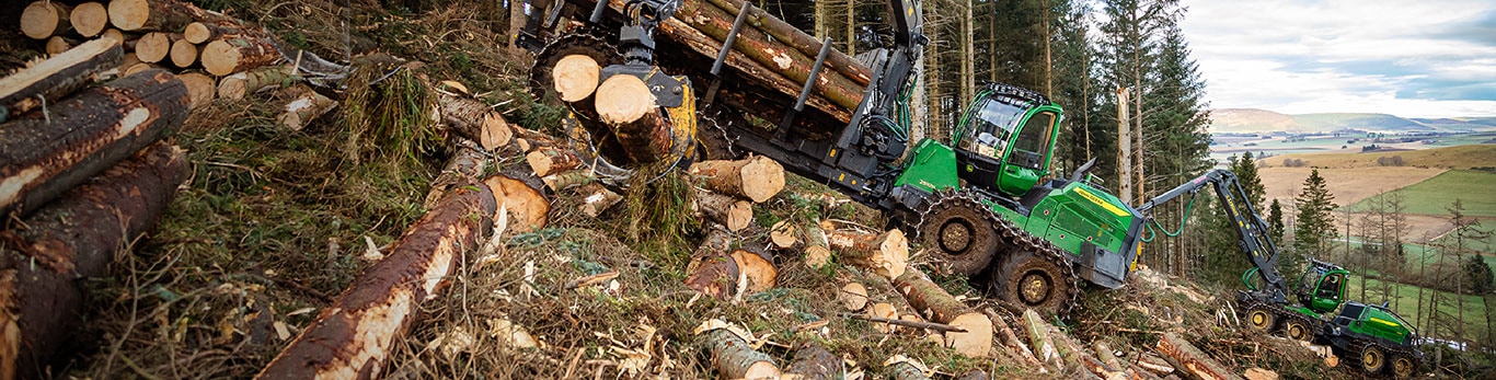 H Series forwarder on a hill surrounded by trees