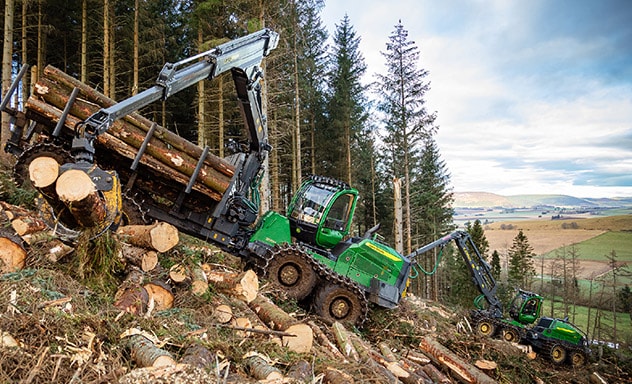 H Series forwarder on a hill surrounded by trees