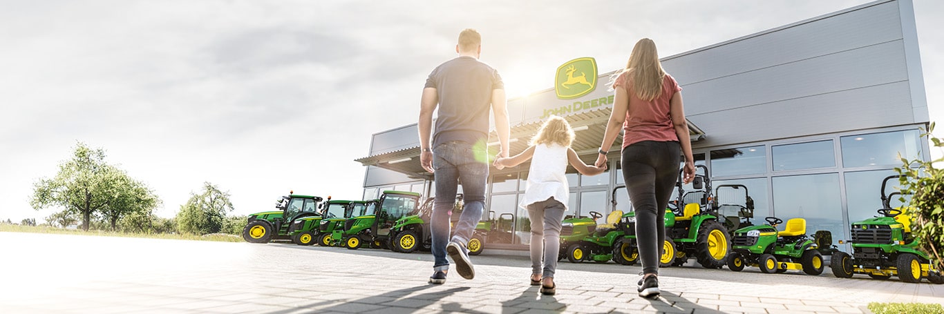 Family walking to John Deere dealership