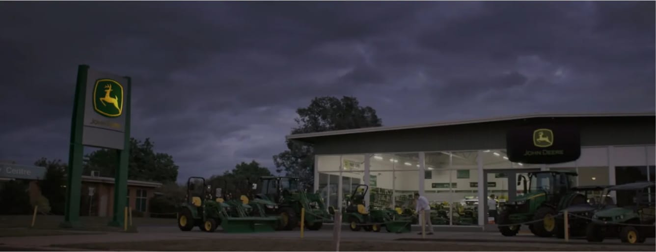 A John Deere dealership at dusk.