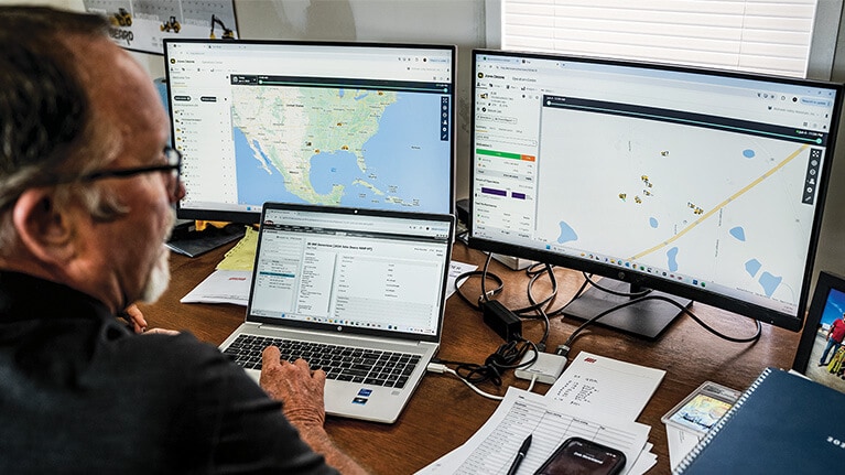 man at office desk using computer