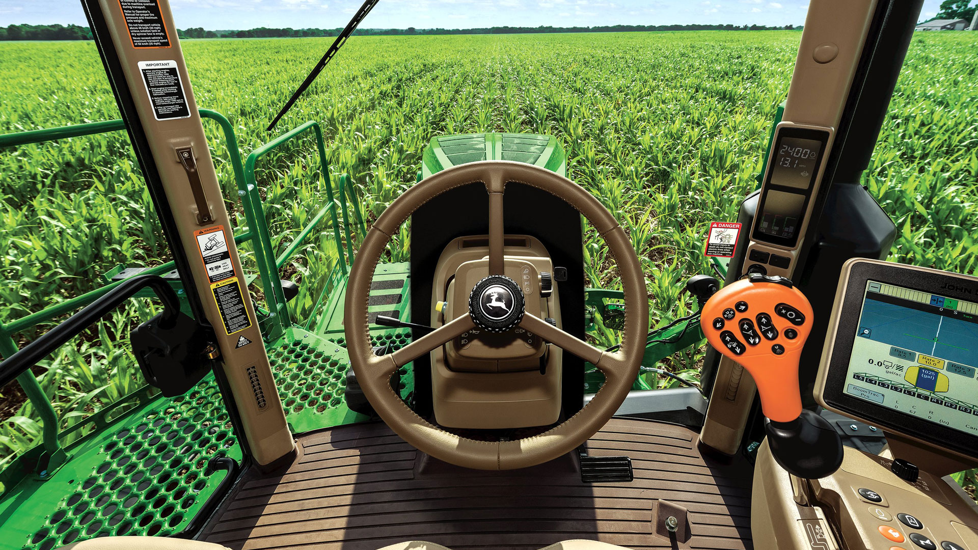 Inside the cab of sprayer looking out to a crop
