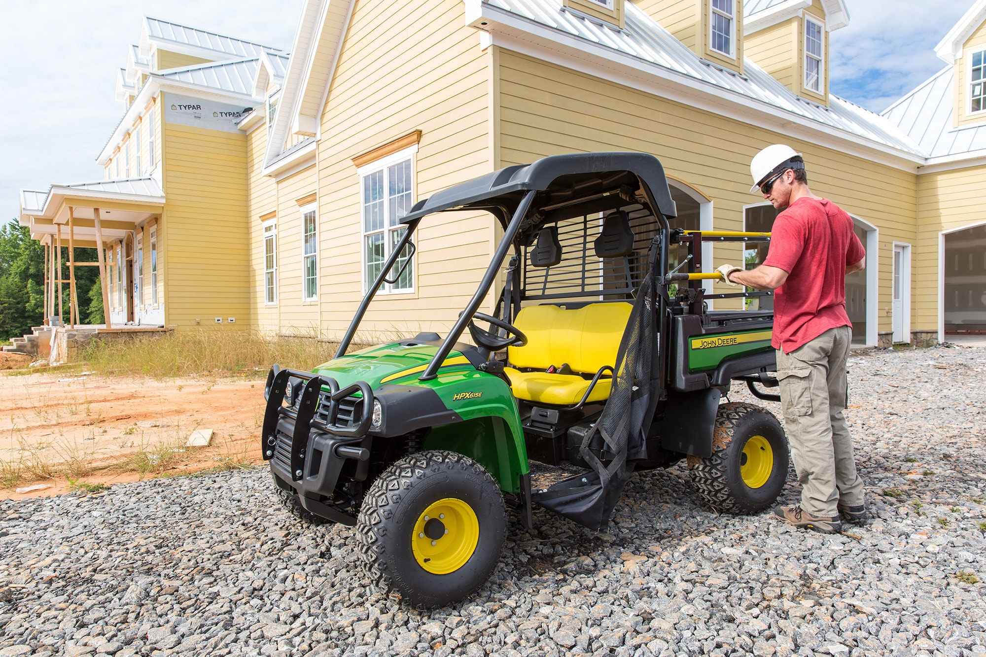 Work Series Gator in front of house being built