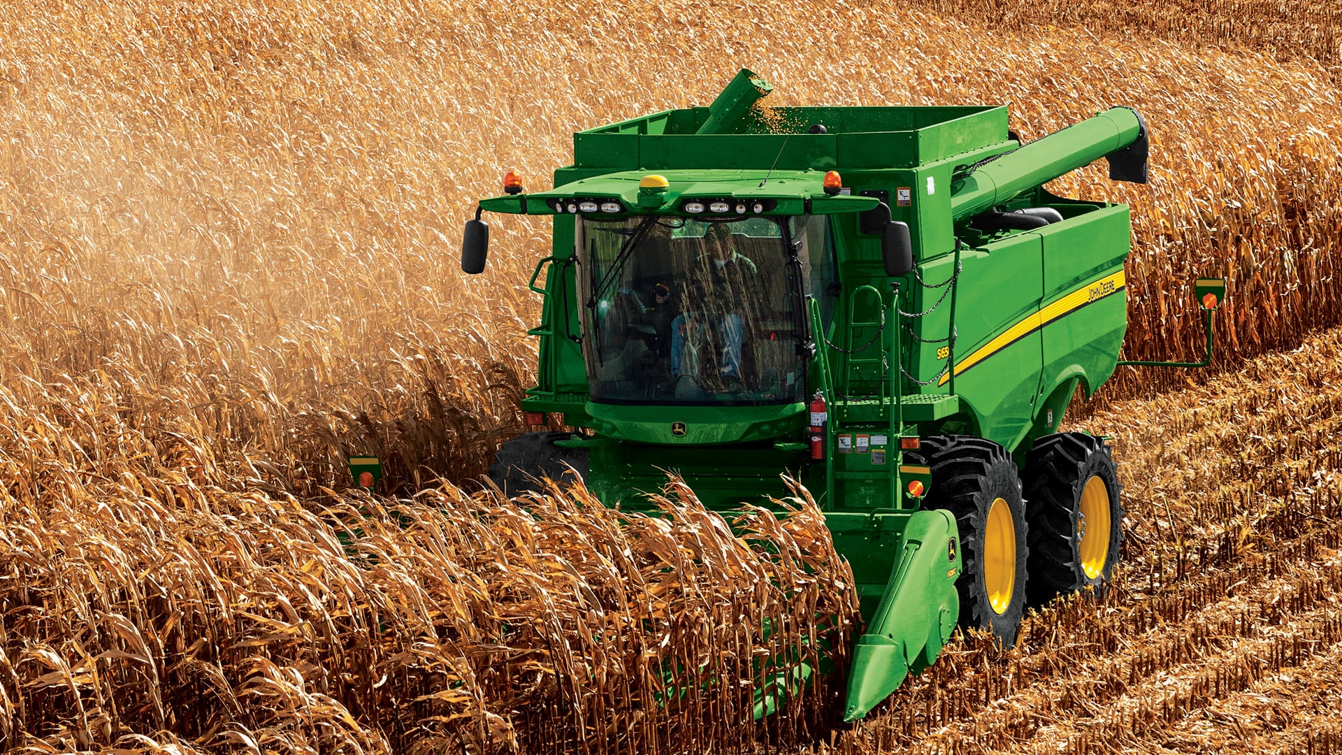 s series combine moving through field overhead view