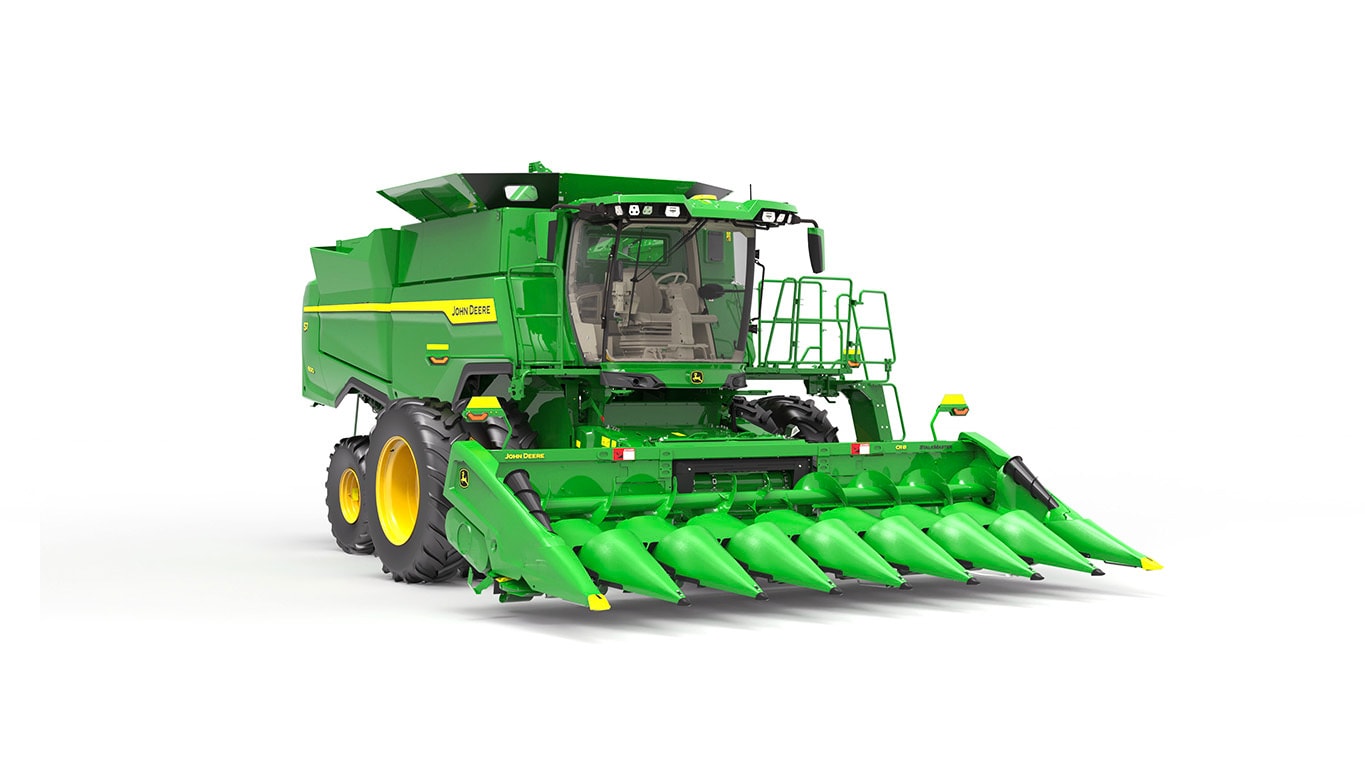 Photo of a John Deere S7 600 combine with a draper head on a white background.