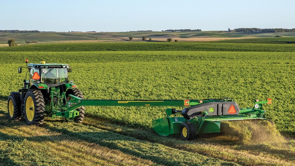 mower conditioner on tractor in field