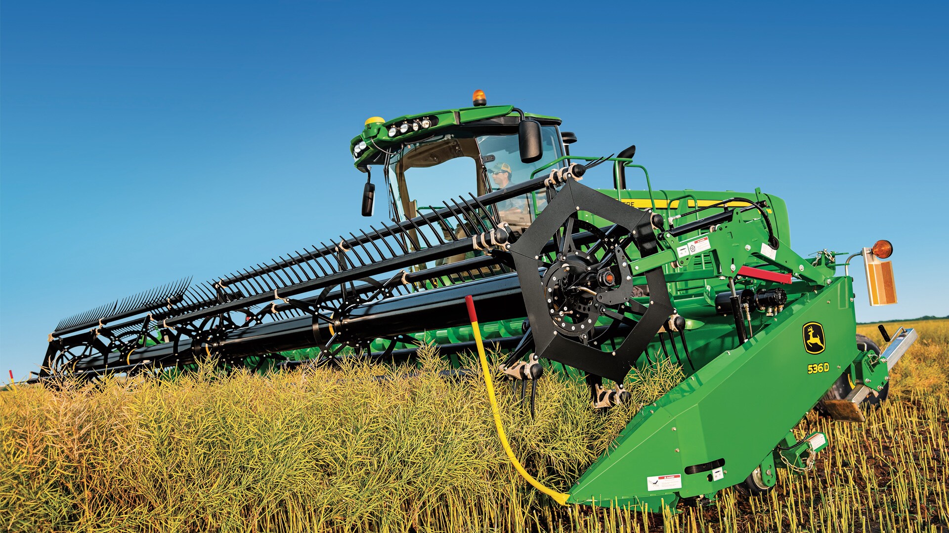 Photo of windrower moving through field