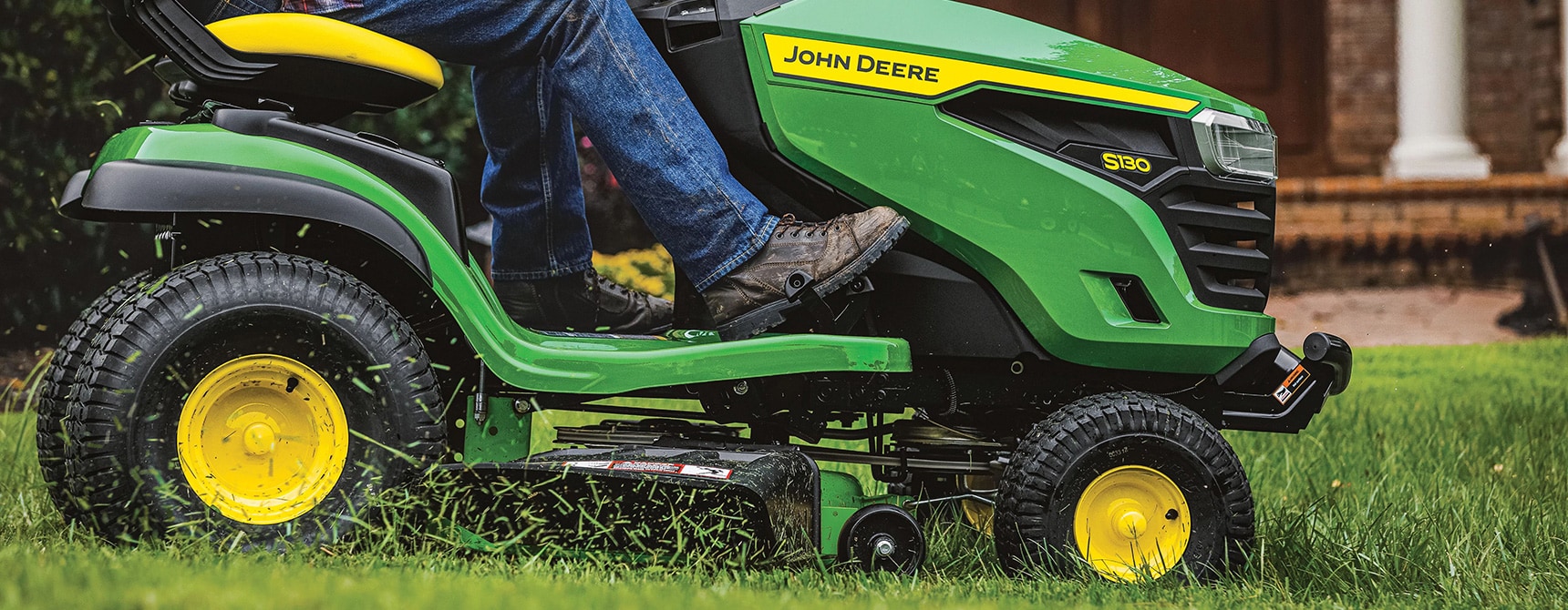 100 Series ride-on mower on residential front lawn