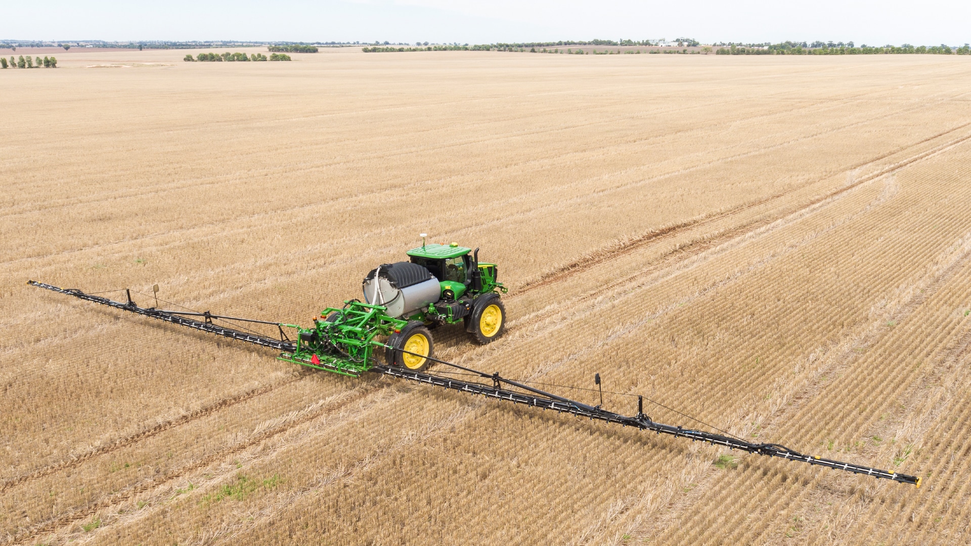 Sprayer equipment out in the field during sunset